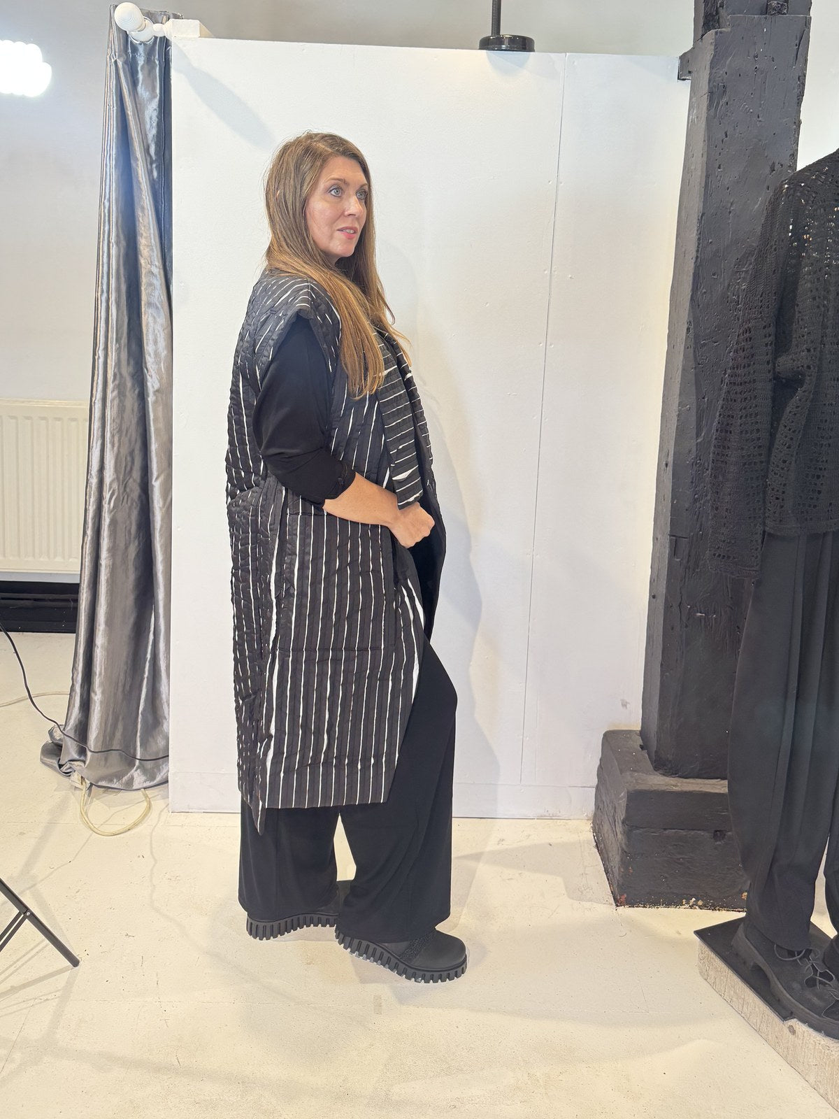 Side view of the Tulip waistcoat showing its side pocket and long striped silhouette