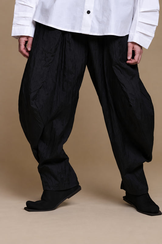 Black crinkle balloon trousers, front view with a wider stance