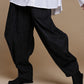 Black crinkle balloon trousers, movement view showing the rounded legs