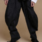 Black crinkle balloon trousers, detail of the textured legs and tapered hems