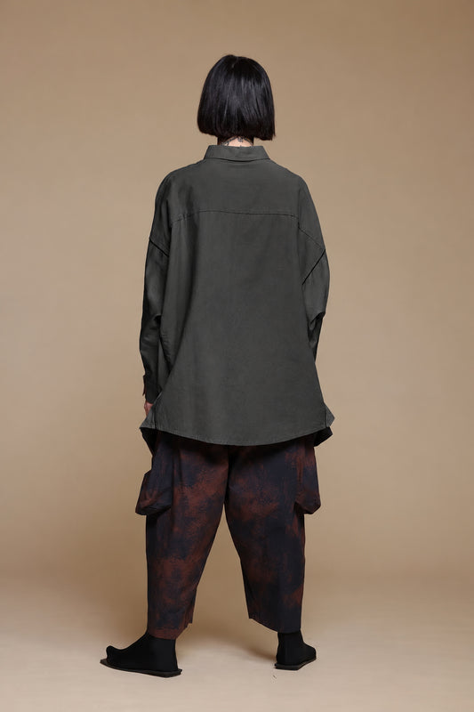 Black cotton pocket shirt, back view showing the curved hem