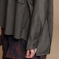 Black cotton shirt, detail of the chest pocket, sleeve cuff and buttons
