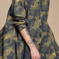 Yellow-olive and charcoal linen shirt, close-up of collar, buttons and rolled sleeve