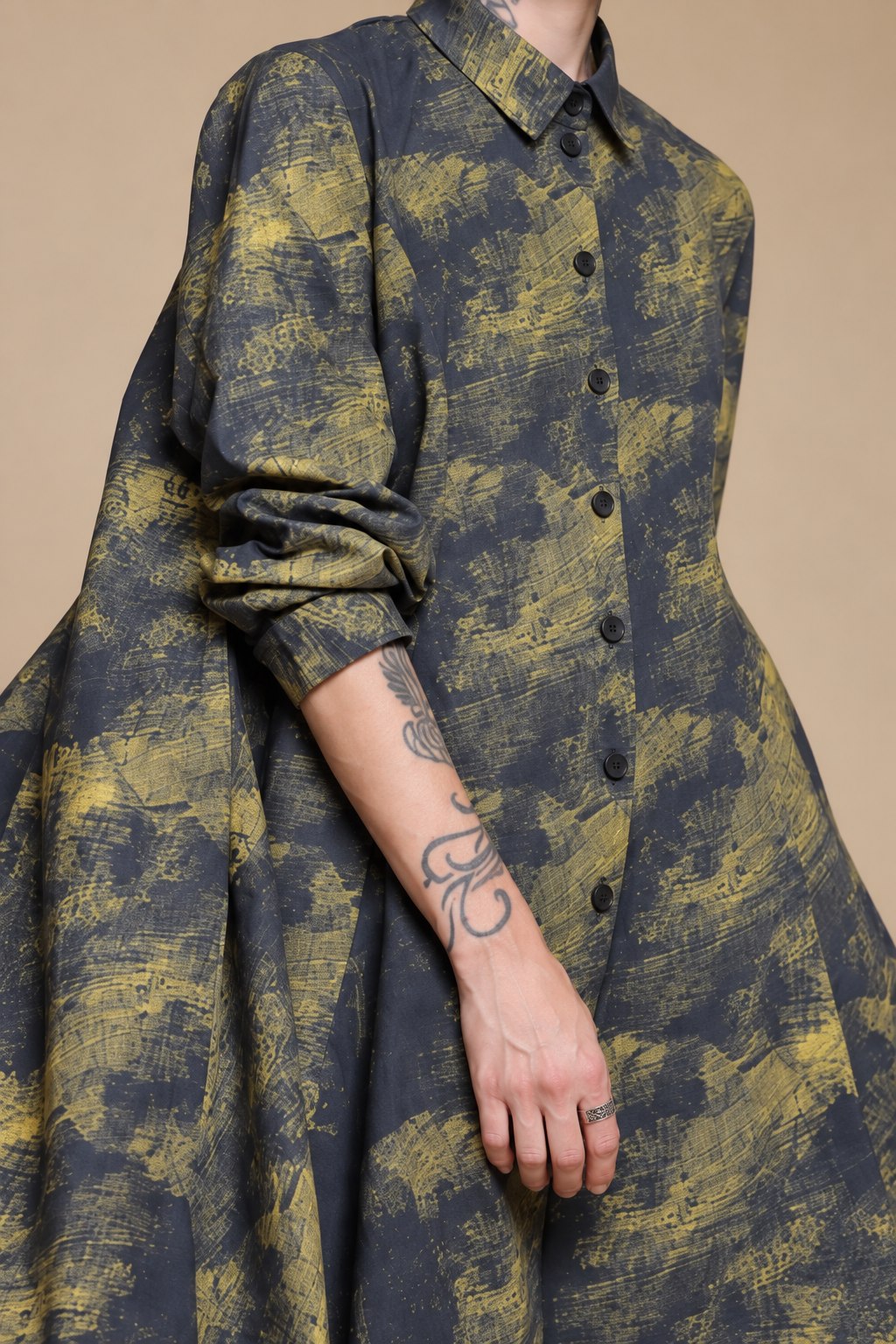 Yellow-olive and charcoal linen shirt, close-up of collar, buttons and rolled sleeve