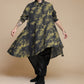 Yellow-olive and charcoal linen shirt in motion, showing the wide flowing hem