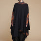 Black draped top layered over a separate printed shirt