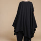 Black draped top, back view showing the long uneven hem