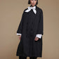 Black Kedem Sasson crinkle jacket, front view over a separate white bow-neck shirt