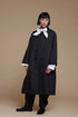Black Kedem Sasson crinkle jacket, front view over a separate white bow-neck shirt