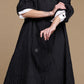 Black crinkle jacket, close-up of the textured fabric and large buttons