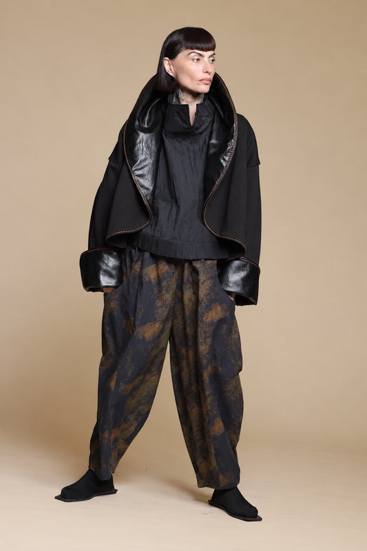 Black glossy-lapel jacket, raised-collar styling with separate printed trousers