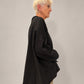 Kedziorek black floral print top, side view showing relaxed volume and curved hem