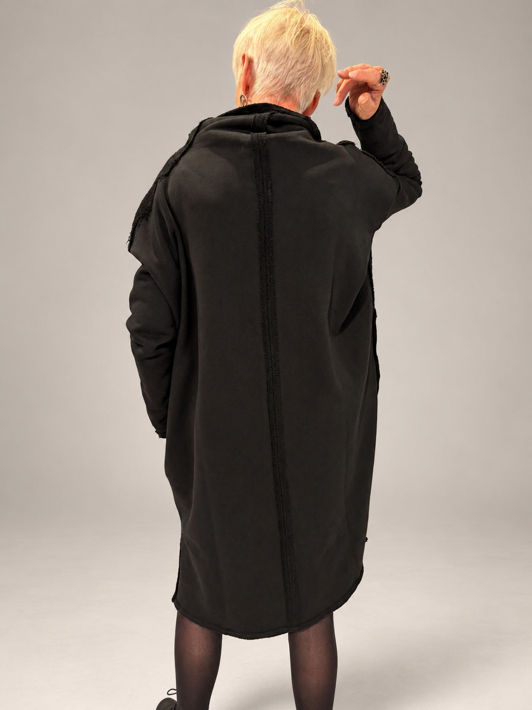 Kedziorek black cotton dress, back view showing raised collar and exposed centre seam