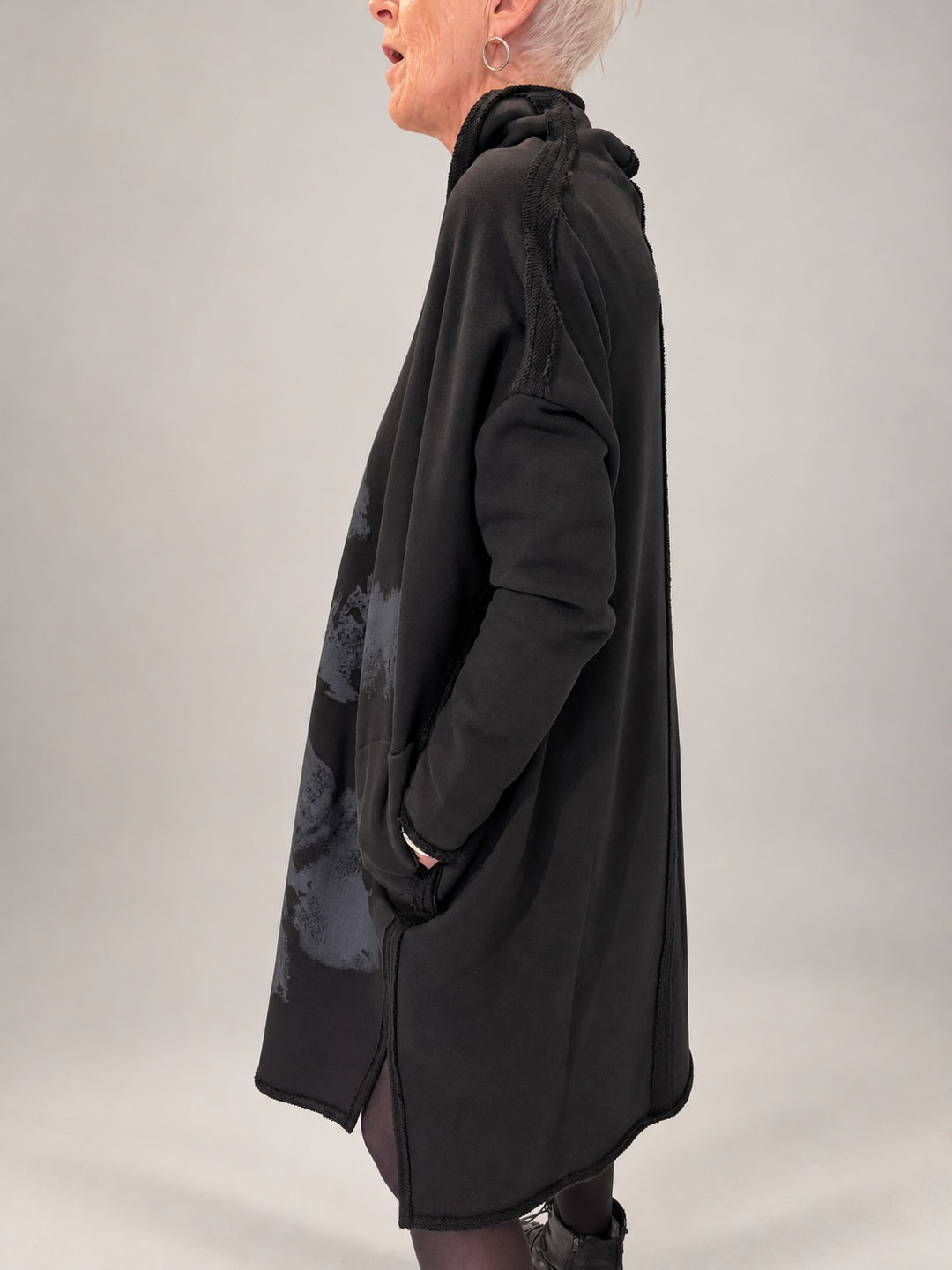 Kedziorek black floral print cotton dress, side view showing pockets and exposed seams
