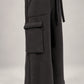 Kedziorek black cotton trousers, close-up of oversized cargo pocket and loopback seam edging