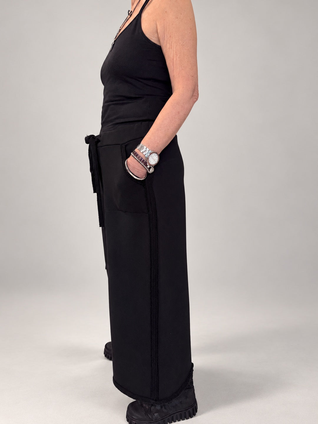 Kedziorek black wide-leg cotton trousers, side view showing cropped length and pocket