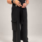 Kedziorek black wide-leg cotton trousers with drawstring waist and oversized cargo pocket, front view