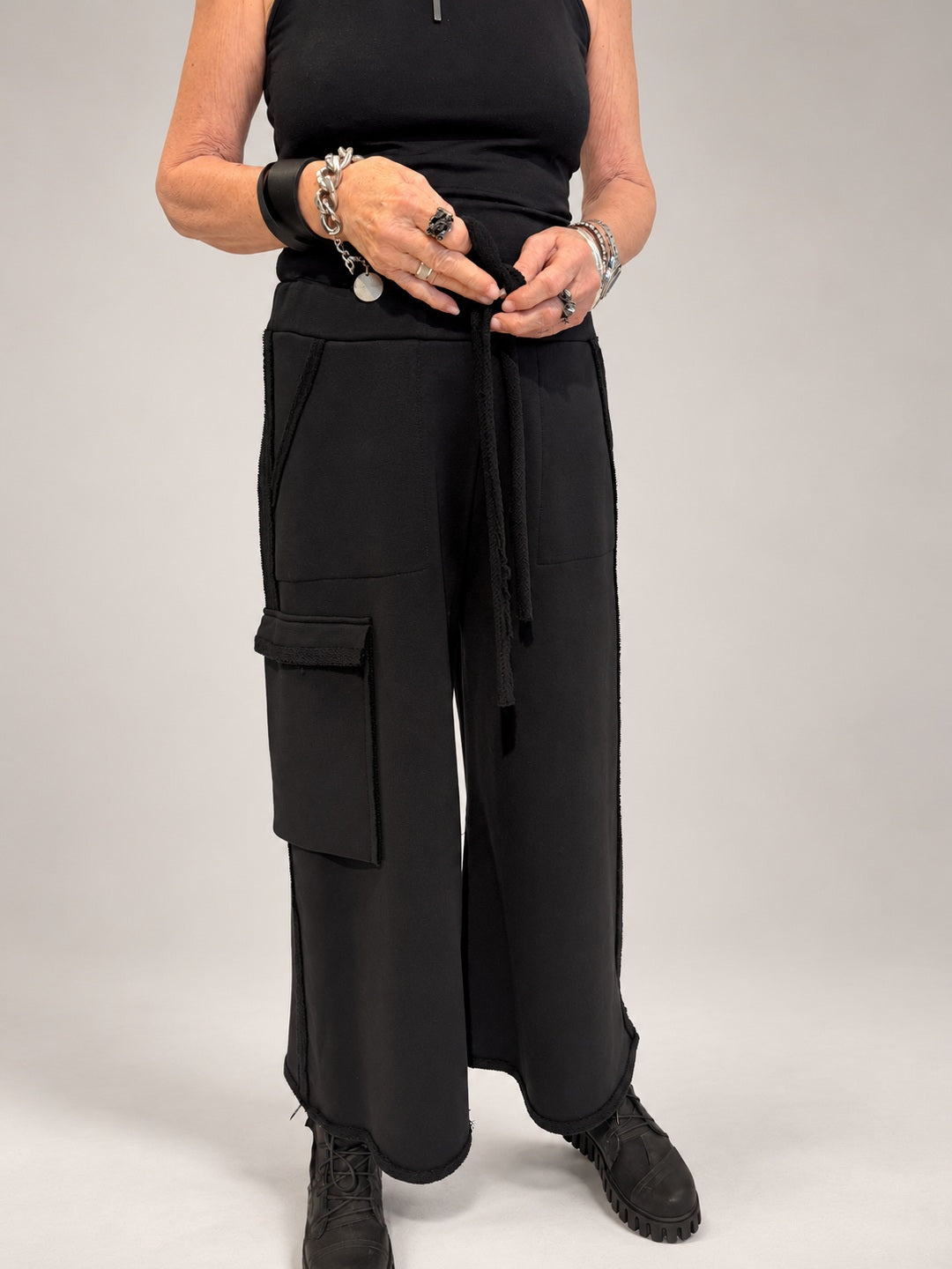 Kedziorek black wide-leg cotton trousers with drawstring waist and oversized cargo pocket, front view