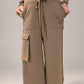 Kedziorek taupe wide-leg cotton trousers with drawstring waist and oversized cargo pocket, front view