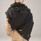 Kedziorek black scarf draped across the back, showing leaf-shaped cut-outs and irregular edge