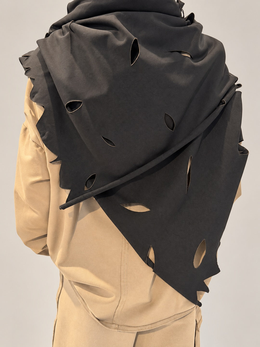Kedziorek black cotton-blend scarf, close-up of leaf-shaped cut-outs and pointed edge across the back