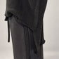 Kedziorek black merino wool top, close-up of stepped hem, side opening and raw-edge knit texture