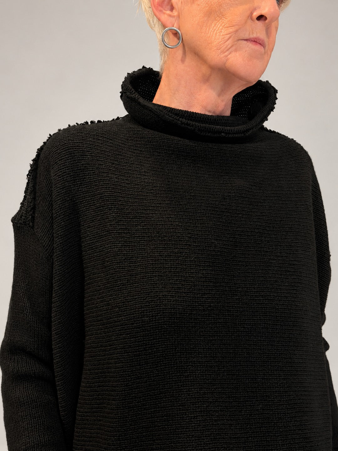 Kedziorek black merino wool top, close-up of raised neckline and textured knit