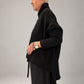 Kedziorek black textured merino wool top, side view showing dropped shoulder and longer back hem