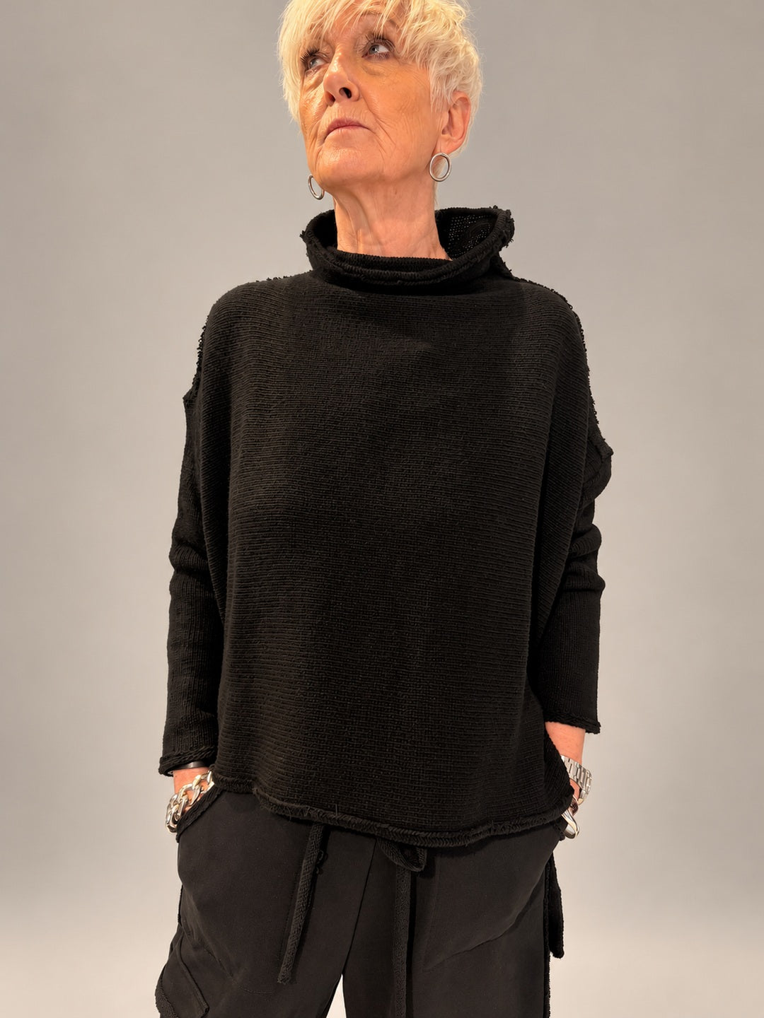 Kedziorek black textured merino wool top with raised neckline and dropped shoulders, front view