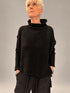 Kedziorek black textured merino wool top with raised neckline and dropped shoulders, front view