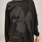 Kedziorek black floral print top with ribbon leaf detail, relaxed sleeves and exposed seams, front view