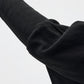 Transit black virgin-wool jumper – fitted sleeve and draped-arm detail